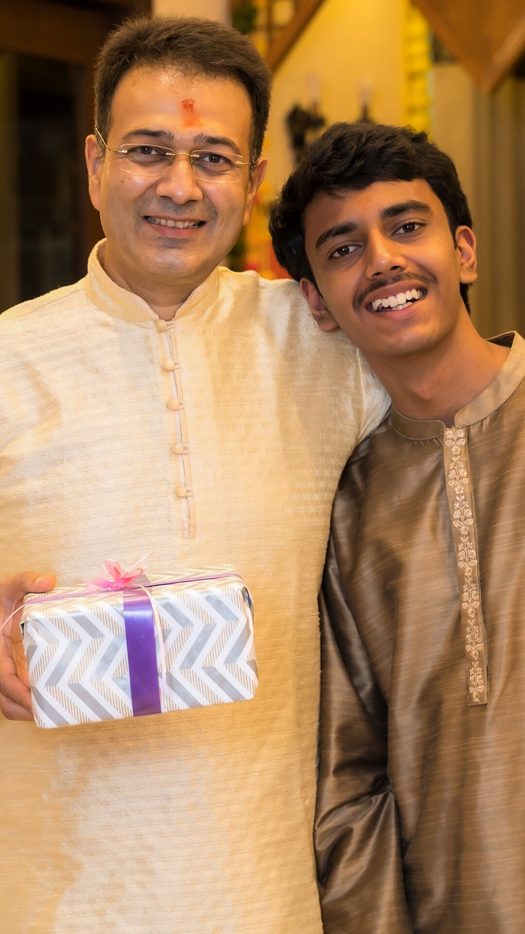 A man wearing a sherwani with gold stone work